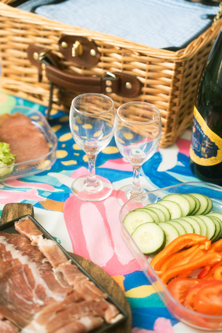Australian Christmas lunch table with leg ham, cooked prawns, pavlova with strawberries, and sparkling wine on a sunlit outdoor table