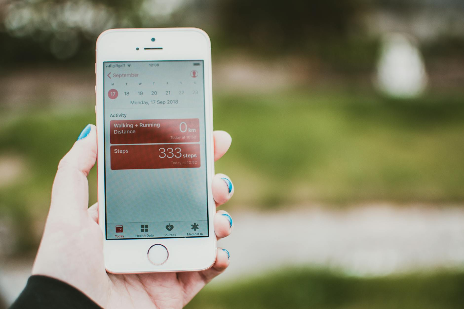 Person using a smartphone app to track macronutrients while preparing a balanced meal in a bright modern kitchen