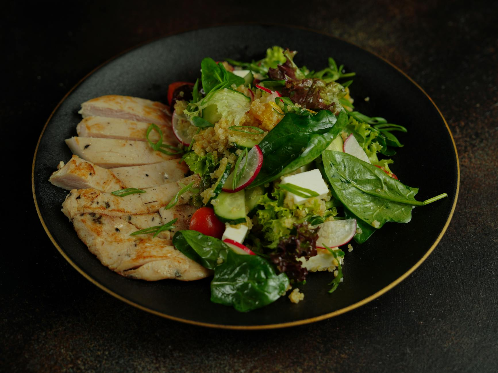 Open notebook with handwritten Mounjaro and Ozempic dose escalation schedule beside a portioned plate of grilled chicken, quinoa, and vegetables and a calorie tracking app on a sunlit Australian kitchen counter