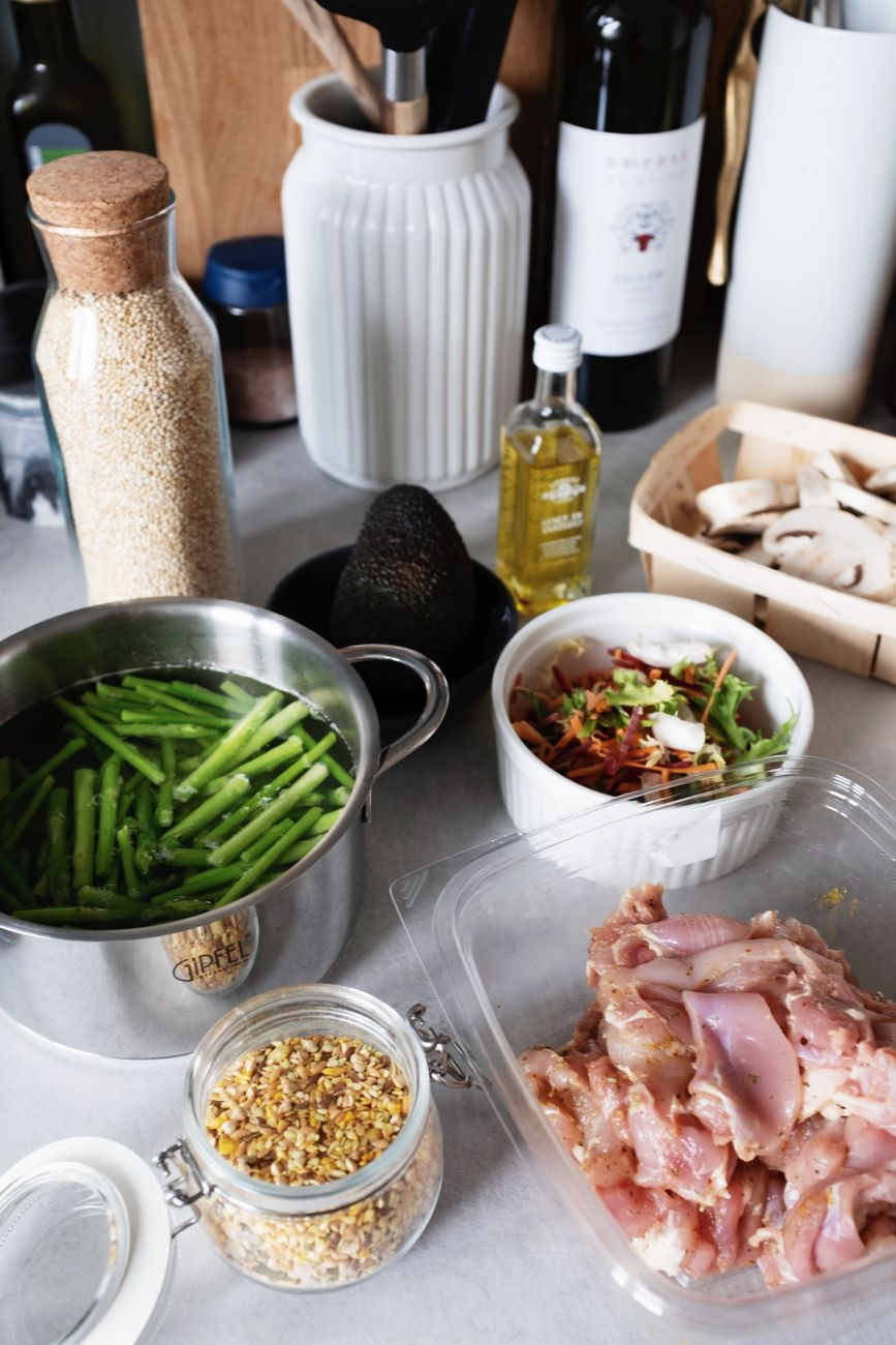 Open HelloFresh recipe card on a sunlit Australian kitchen counter beside a kitchen scale, fresh chicken, vegetables, herbs, and pantry oil ready for prep