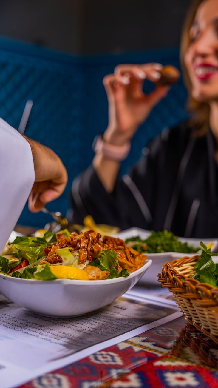 Traveler enjoying a balanced meal at a restaurant with local cuisine, fresh vegetables, and grilled protein